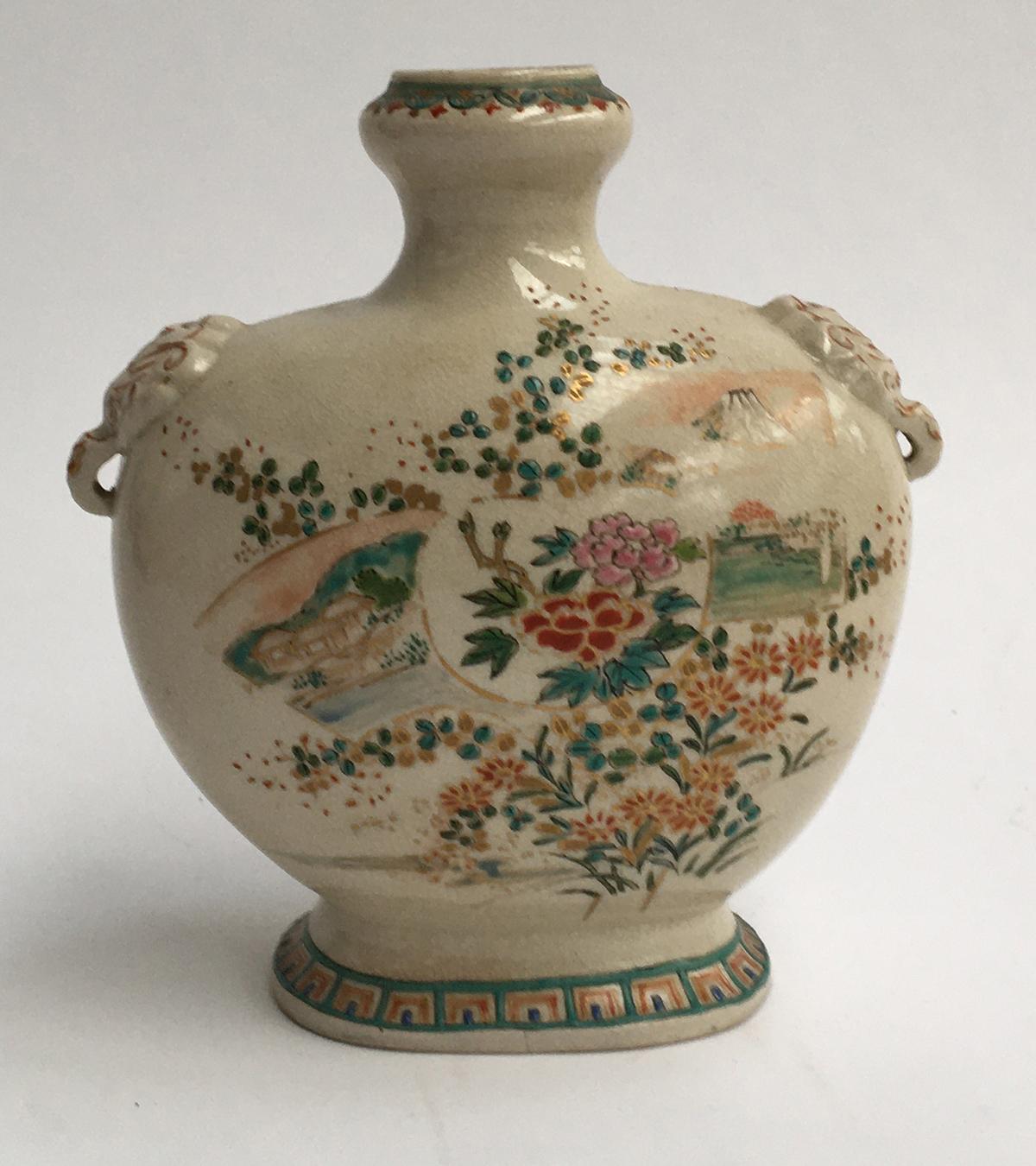 An antique Japanese Meiji period enamelled vase with elephant lugs, decorated with views of Mount
