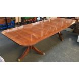 A very large 20th century mahogany crossbanded dining table, on twin columns, each with three