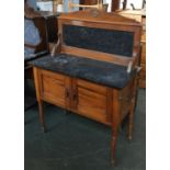 An early 20th century marble wash stand, with marble back, over two cupboard doors on turned legs