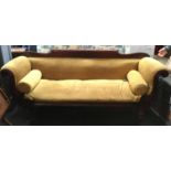 A 19th century sofa, possible Irish, carved mahogany outward scrolling arms, raised on turned legs