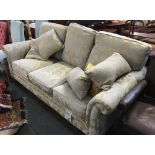 A three seater sofa, outswept arms on turned feet, approx. 200cmW