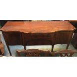 A Regency mahogany break front sideboard, two drawers, one concealed, flanked by two cupboard doors,