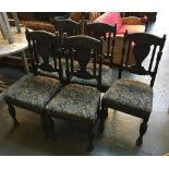 A set of five carved oak dining chairs with upholstered seats