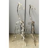 A pair of wrought iron kettle stands, each approx. 88cmH