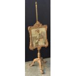 A 19th century giltwood pole fire screen, with glazed grospoint panel, on three giltwood cabriole