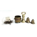 A mixed lot to include 7lb brass weight; several brass bells; small brass planter; and a quantity of