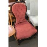 A buttonback salon chair with floral carved rail, cabriole legs and brass casters