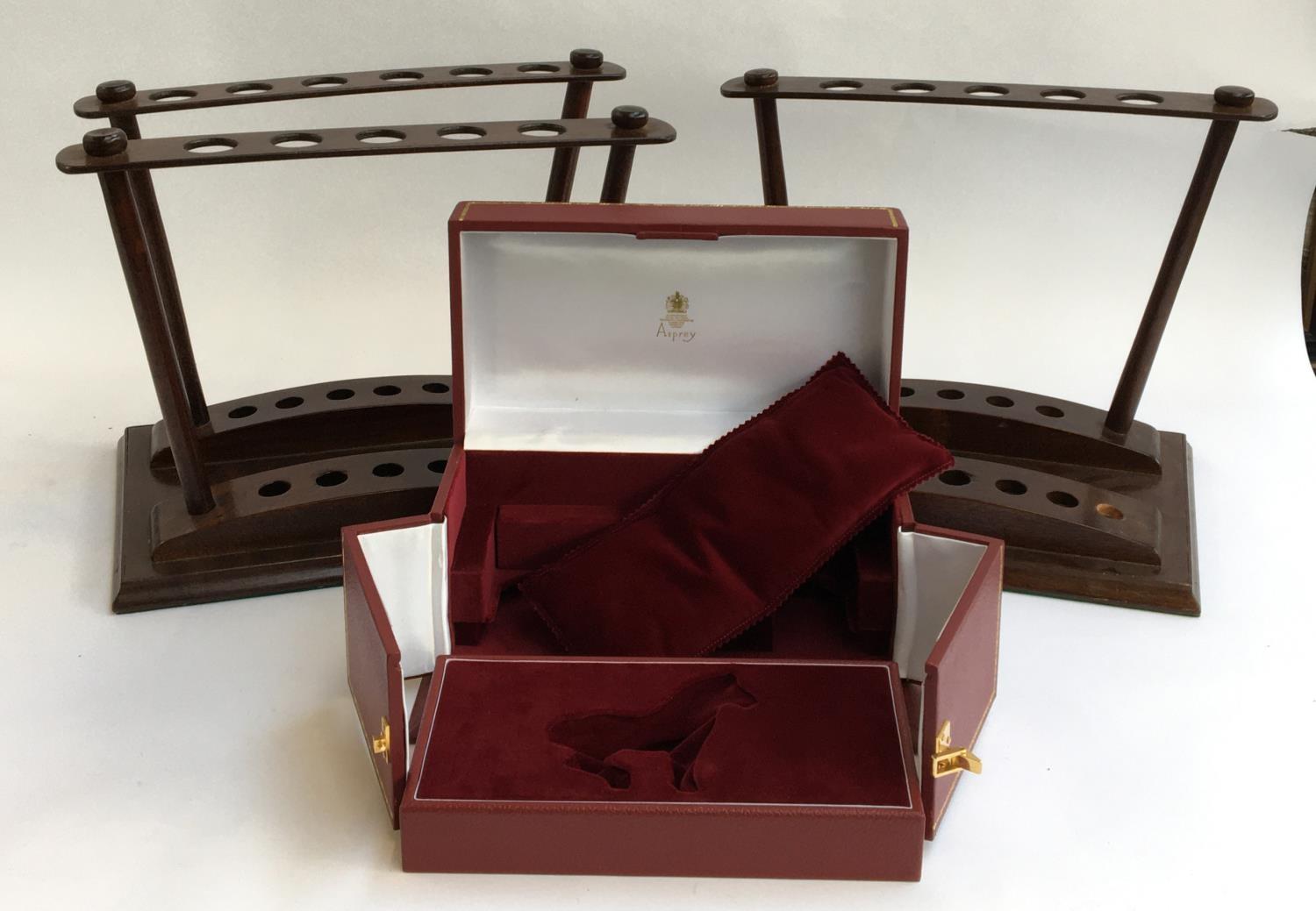 An Asprey presentation box; together with two Asprey wooden stands