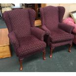 A pair of Parker Knoll wingback armchairs on cabriole legs