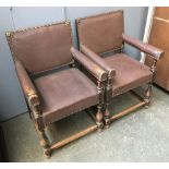 A pair of 20th century leather upholstered open armchairs, on baluster turned legs, joined by
