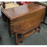 A 20th century oak gateleg table, the top with shaped edge, on barley twist supports, 90cmW