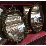 A gilt framed rectangular wall mirror with bevelled glass, 58x47cm; together with two other oval