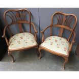 A pair of mahogany open armchairs, on cabriole legs