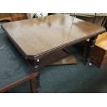 A mahogany dining table on heavy turned legs and casters, with two spare leaves, 120x103x71cm