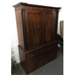 A Victorian mahogany linen press, doors flanked by doric columns, opening to reveal five slides,