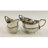 A half gadrooned silver milk jug and sugar bowl by Thomas Hayes, Birmingham 1898, 5oz