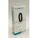 A Fitbit Alta wristband, boxed