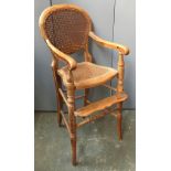 A Victorian beech child's high chair, with caned back and seat