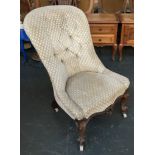 A buttonback continental bedroom chair, serpentine front with carved apron and scrolling cabriole