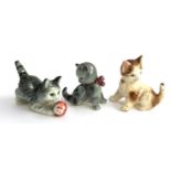 Three Goebel cat figurines, two with bugs