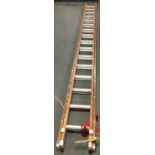 A two-part wood and aluminium extending ladder, each section 420cm