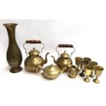 A mixed lot of brass items to include several kettles, tall vase, jug and six goblets