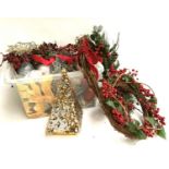 A large box of Christmas wreathes and other decorations