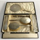 A silver vanity set comprising clothes brushes (2), hair brushes (2), vanity mirror and comb, Adie