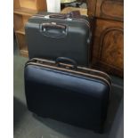 A Delsey pull along suit case, together with one other suitcase