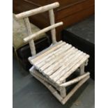 An unusual whitewashed child's chair by Emily Readett-Bailey