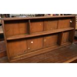 A mid-century Ercol plate rack, two shelves, 107cmW