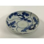 A small Japanese porcelain plate, blue and white with lucky charm plant and bamboo design, marks