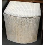 A Lloyd Loom style wicker laundry basket