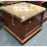 A small mahogany ottoman with grospoint upholstered hinged lid, 49cm2