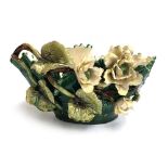 A Majolica style vase, encrusted with large flowers and leaves, 39cmW