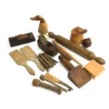 A mixed lot of wooden items to include treenware checkered darning mushroom; clothes pegs; butter