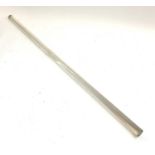 A long glass rod, possibly a ledger magnifier or desk rule