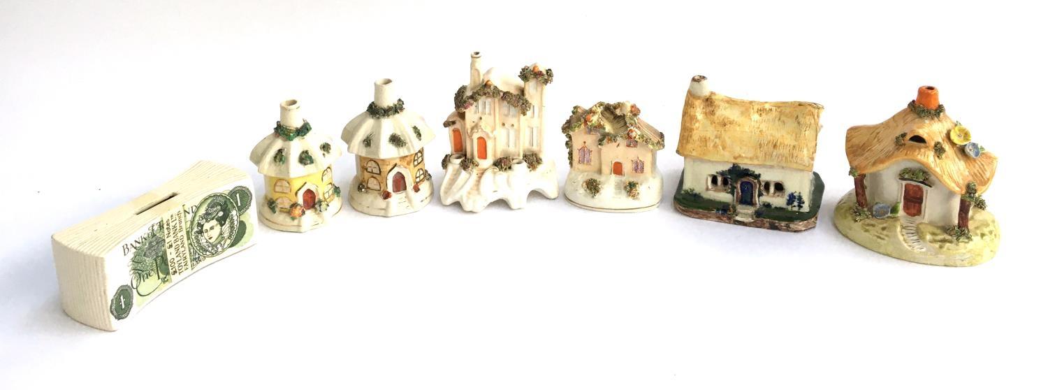 Two flatback cottages together with four others; together with a Toyland banknote moneybox