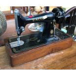 A Singer sewing machine with electric motor, serial no. EK587422, in case