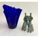 A blue art glass vase, 27cmH; together with a studio ceramic figure of parents with child, 18.5cmH