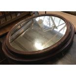 A pair of mahogany framed oval wall mirrors, 64x55cm