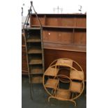 A circular bamboo shelving unit, 68cmH; together with a further wicker CD rack