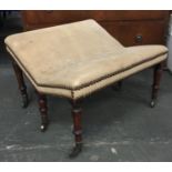 An unusual 19th century footstool, on six turned legs with turned stretcher, upholstered in suede