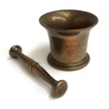 A brass pestle and mortar, the pestle 18.5cmL, the mortar 13cmD