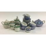 A miniature blue lustre tea set together with one other