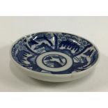 A Japanese Kozara porcelain blue and white plate, Seigaiha pattern, marks to base, 11cmD