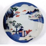 A Japanese porcelain plate, decorated sansui mountain scenery, in blue, green and red, heightened in