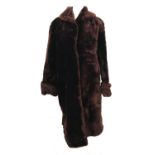 A ladies fur coat, with rolled collar and turned back cuffs, approx size 10