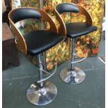 A pair of chrome, leather and bentwood swivel bar stools with adjustable height