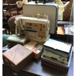 A Singer 'Golden Panoramic 670G' sewing machine in carry case, together with accessories including